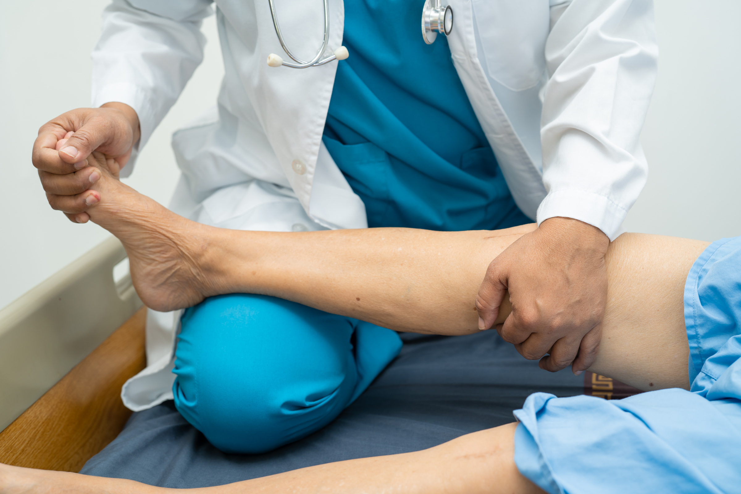 Asian Doctor Physiotherapist Examining, Massaging and Treatment